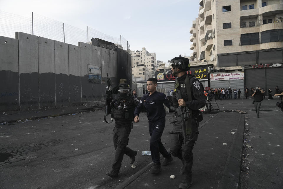 FILE - Israeli police arrests a Palestinian during clashes in Shuafat refugee camp in east Jerusalem, Wednesday, Oct.12. 2022. The clashes began after Israeli security forces set up checkpoints that choked off the only exit and entry points of the camp during a manhunt following the death of a soldier, bringing life to a standstill for its estimated 60,000 residents. (AP Photo/Mahmoud Illean, File)