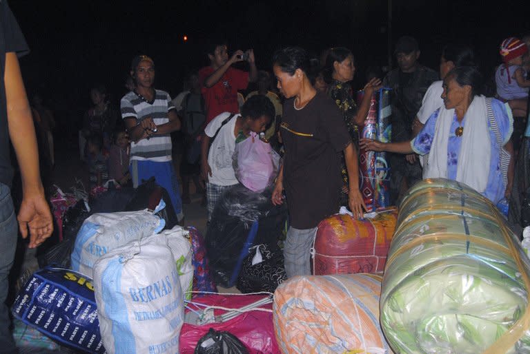 Filipino families wait for transport at the port of Jolo after fleeing escalating tensions between Filipino gunmen and Malaysian security forces in Sabah late on March 3, 2013. A total of 27 people have been reported killed after two deadly shootouts in Sabah on Borneo island where militants landed on February 12