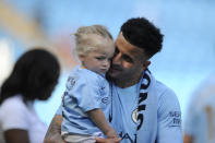 <p>Manchester City’s Kyle Walker holds a girl after the English Premier League soccer match between Manchester City and Huddersfield Town at Etihad stadium in Manchester, England, Sunday, May 6, 2018. (AP Photo/Rui Vieira) </p>