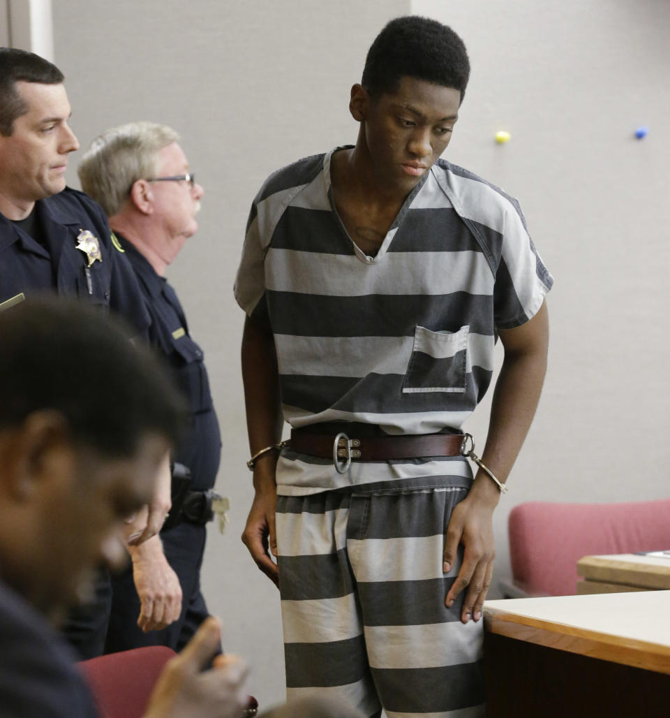 Sir Young, 20, is led into court before a hearing in Dallas Thursday, May 8, 2014. A district court judge has reversed a previous order and imposed a series of probationary requirements for the 20-year-old man convicted of raping a schoolmate. The initial punishment for Young sparked a backlash when a prior judge in Dallas sentenced him to five years of probation and declined to impose standard conditions of probation for sex offenders. (AP Photo/LM Otero)