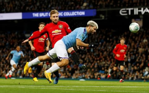 Manchester City's Sergio Aguero misses a chance to score as Manchester United's Luke Shaw looks on - Credit: REUTERS