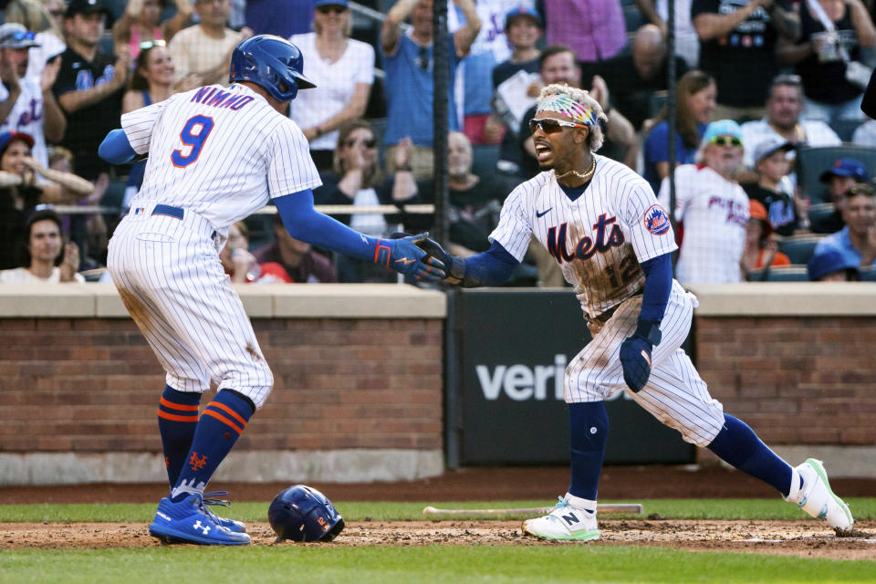 New York Mets' Brandon Nimmo and Francisco Lindor celebrate after scoring during the third inning of a baseball game against the Atlanta Braves, Sunday, Aug. 7, 2022, in New York. (AP Photo/Julia Nikhinson)