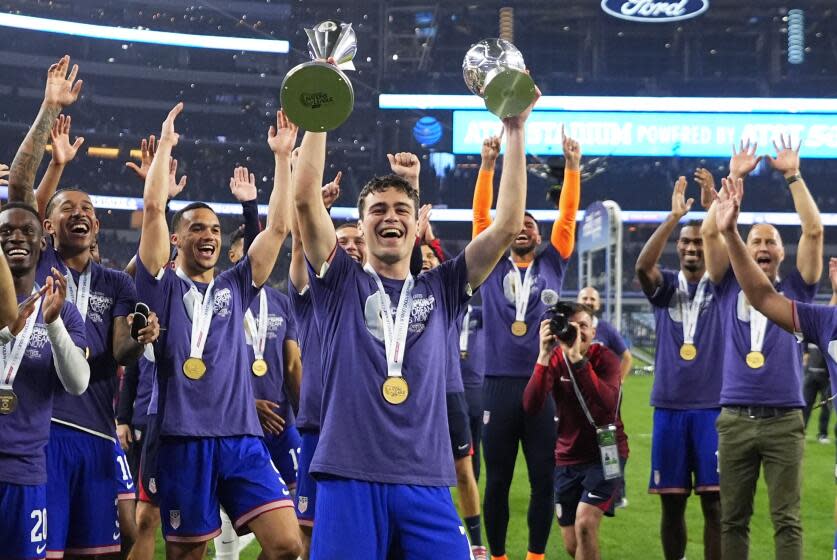 United States forward Gio Reyna, center, and teammates celebrate after a win over Mexico in a CONCACAF Nations League final soccer match, Sunday, March 24, 2024, in Arlington, Texas. (AP Photo/Julio Cortez)