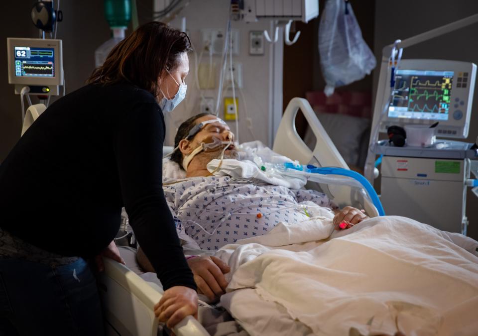 Jennifer prays over her father in the ICU.