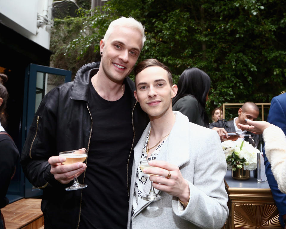 Rippon and Kajaala hold glasses as they pose for a photo at an event