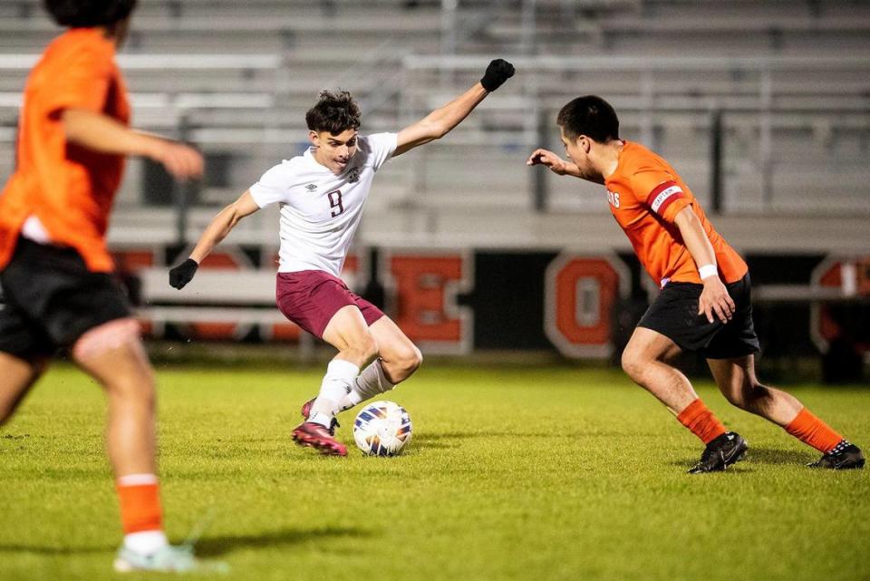 Golden Valley senior Carlos Miranda (9) attempts to get past a Merced defender during a game at Merced High School in Merced, Calif., on Thursday, Jan. 11, 2024. The Cougars beat the Bears 3-1.