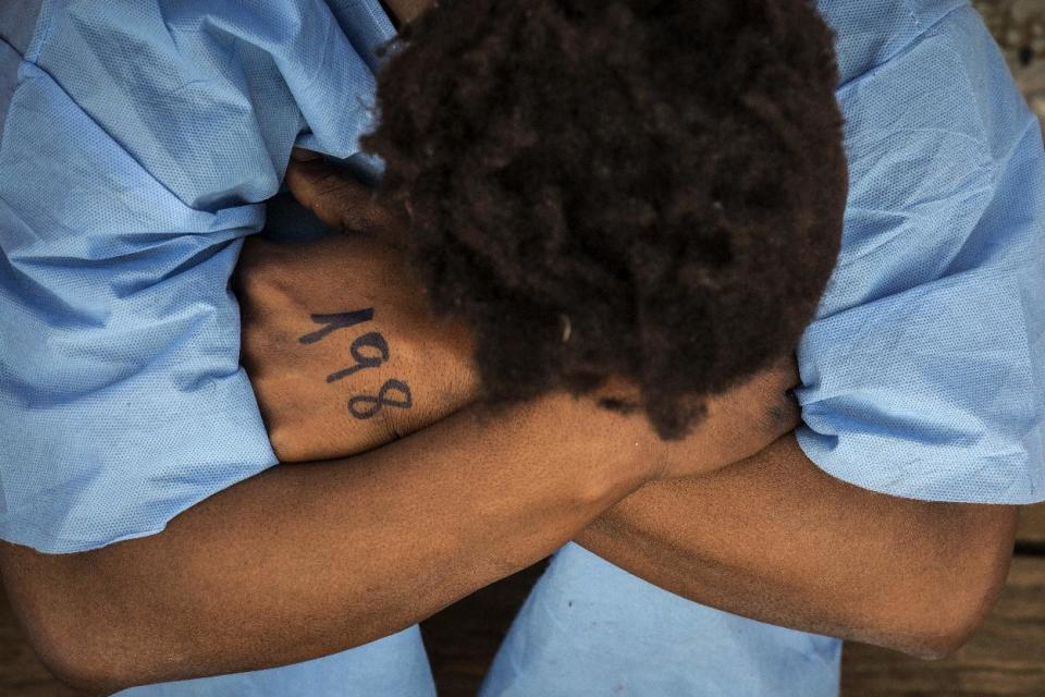 In this Friday Jan. 13, 2017 photo, a woman from Mali sits on the deck of the Golfo Azzurro vessel after being rescued from the Mediterranean sea, about 20 miles north of Ra's Tajura, Libya. Spain's maritime rescue service says the bodies of seven African migrants have been found dead along the Strait of Gibraltar since Friday. (AP Photo/Olmo Calvo)