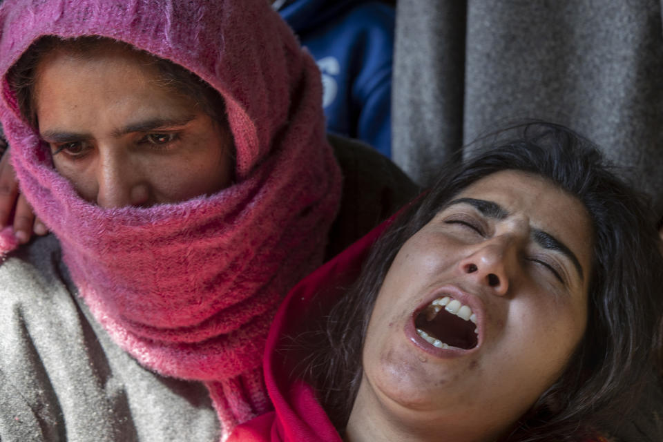 Kashmiri woman wail outside a house allegedly ransacked by security forces after suspected militants killed a policeman in Beerwah area, Indian controlled Kashmir, Friday, Feb. 19, 2021. Anti-India rebels in Indian-controlled Kashmir killed two police officers in an attack Friday in the disputed region's main city, officials said. Elsewhere in the Himalayan region, three suspected rebels and a policeman were killed in two gunbattles. (AP Photo/Dar Yasin)