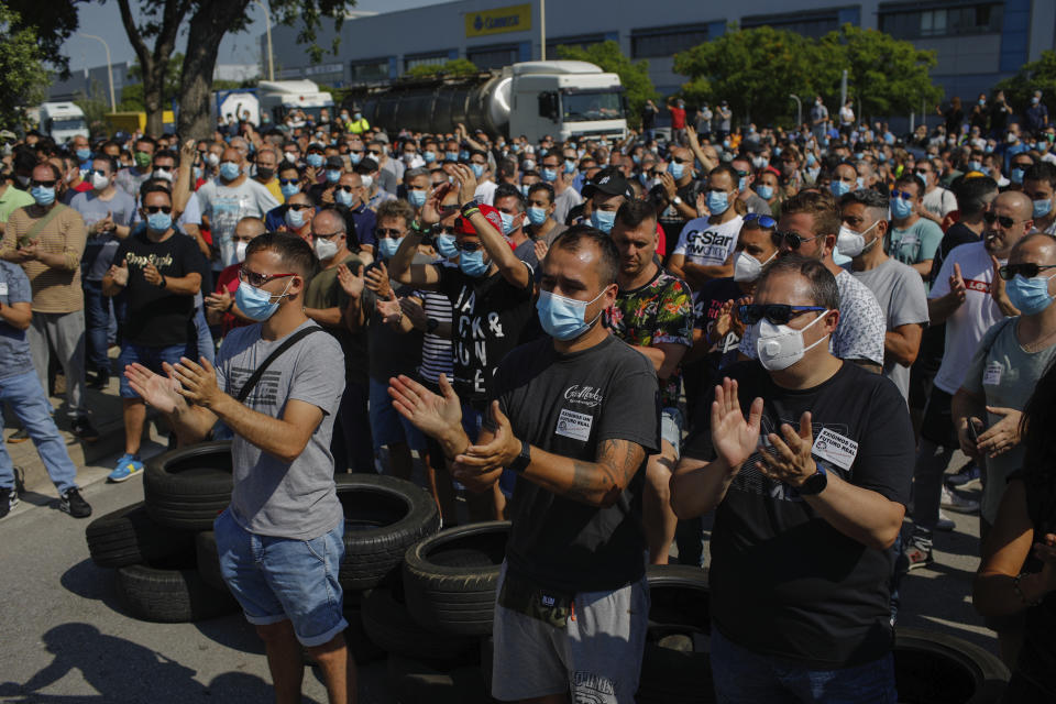 Nissan workers gather during a protest in Barcelona, Spain, Thursday, May 28, 2020. Japanese carmaker Nissan Motor Co. has decided to close its manufacturing plans in the northeastern Catalonia region, resulting in the loss of some 3,000 direct jobs. (AP Photo/Emilio Morenatti)