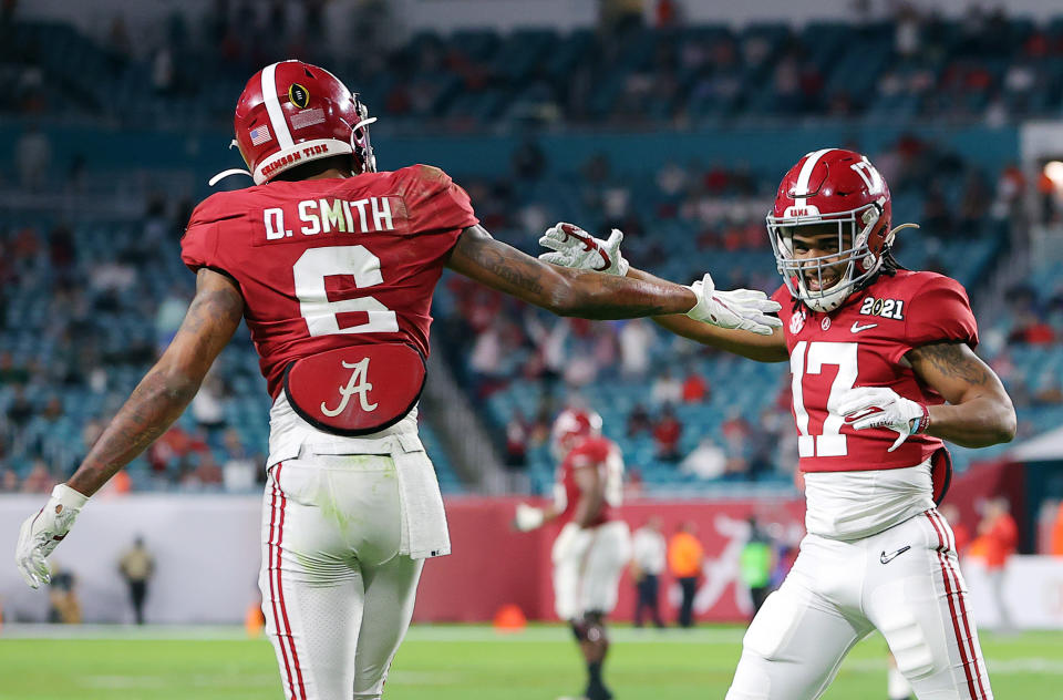 MIAMI GARDENS, FLORIDA - JANUARY 11: DeVonta Smith #6 of the Alabama Crimson Tide celebrates his touchdown with Jaylen Waddle #17 during the second quarter of the College Football Playoff National Championship game against the Ohio State Buckeyes at Hard Rock Stadium on January 11, 2021 in Miami Gardens, Florida. (Photo by Kevin C. Cox/Getty Images)