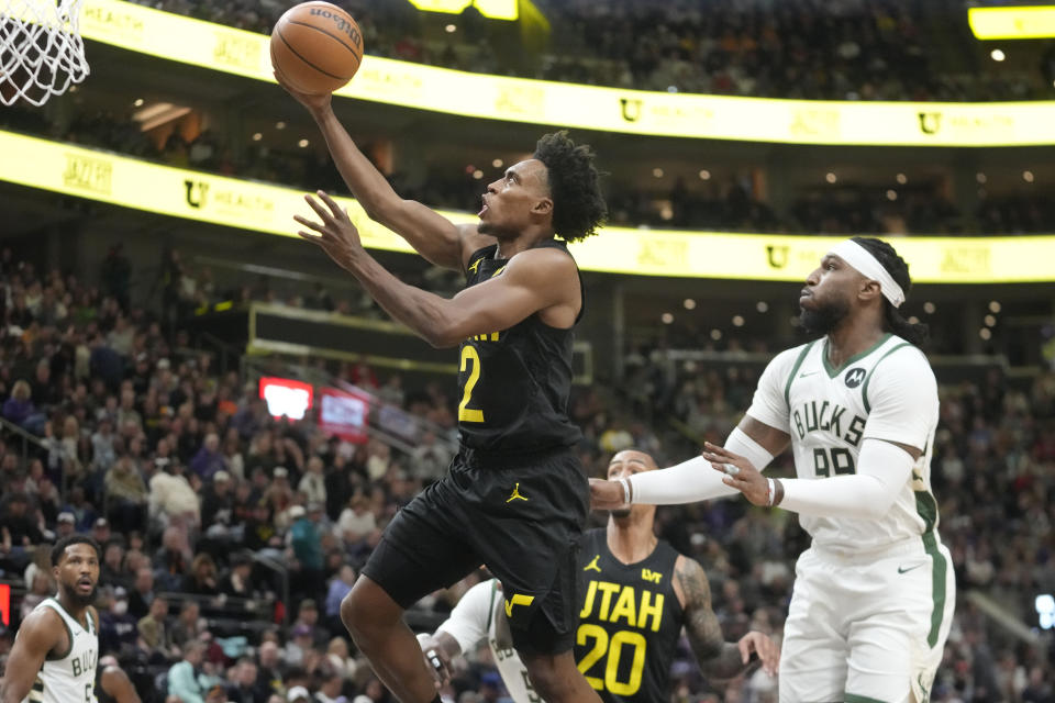 Utah Jazz guard Collin Sexton (2) goes to the basket as Milwaukee Bucks forward Jae Crowder, right, defends during the first half of an NBA basketball game Sunday, Feb. 4, 2024, in Salt Lake City. (AP Photo/Rick Bowmer)