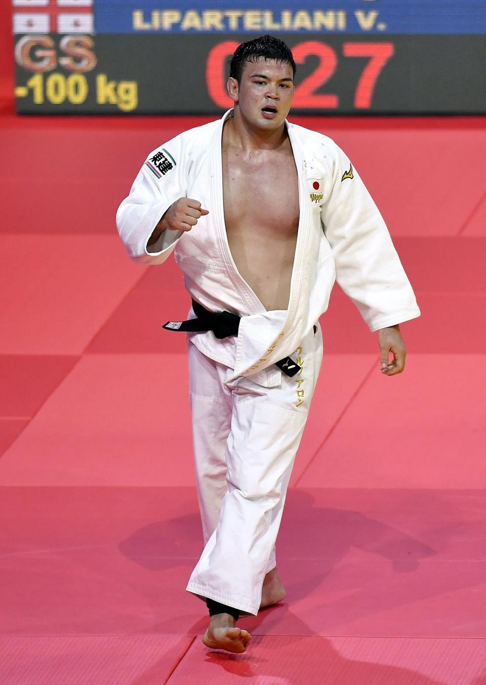 FILE - Aaron Wolf of Japan walks off the mat after winning against Varlam Liparteliani of Georgia in the men's 100kg category at the World Judo Championships in Budapest, Hungary, in this Saturday, Sept. 2, 2017, file photo. Judo is coming home at the Tokyo Olympics “It’s such a lucky opportunity to attend the Olympics in Japan where judo was born," Japanese Olympian Aaron Wolf recently told Japan's Sportiva magazine. “I want to win on this stage. My goal is a gold medal.” (Tibor Illyes/MTI via AP, File)