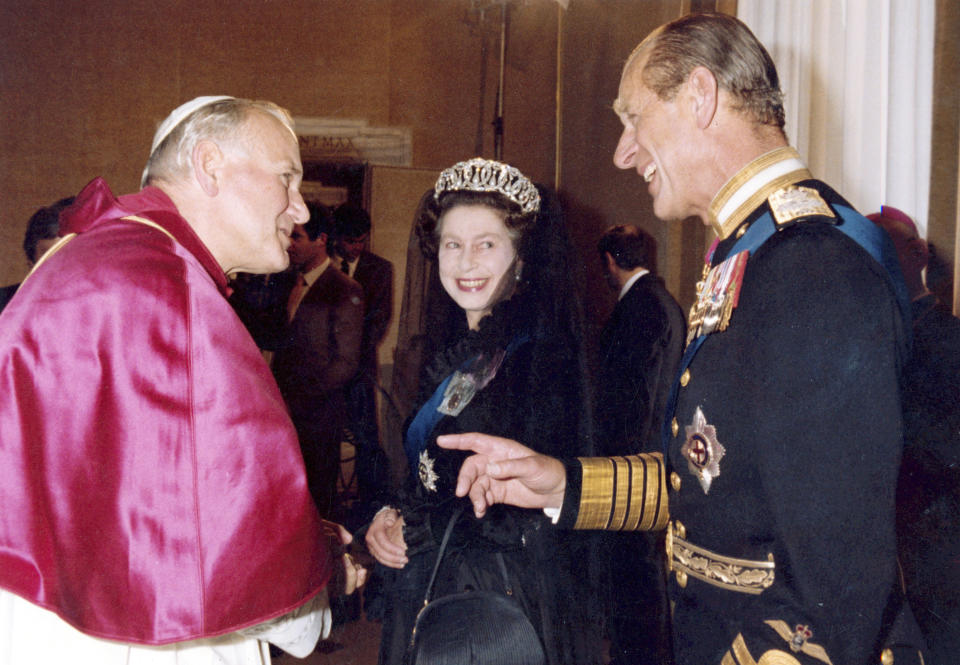 FILE - In this Oct. 17, 1980 file photo, Britain's Queen Elizabeth II, smiles at her husband Prince Philip, during an audience with Pope John Paul II in his private study at the Vatican, Italy. Buckingham Palace officials say Prince Philip, the husband of Queen Elizabeth II, has died, it was announced on Friday, April 9, 2021. He was 99. Philip spent a month in hospital earlier this year before being released on March 16 to return to Windsor Castle. Philip, also known as the Duke of Edinburgh, married Elizabeth in 1947 and was the longest-serving consort in British history. (AP Photo/Arturo Mari, File)