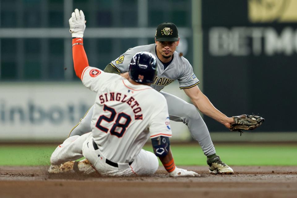 Willy Adames of the Brewers tags Jon Singleton of the Astros out at second base as he tried to stretch a single in the second inning.