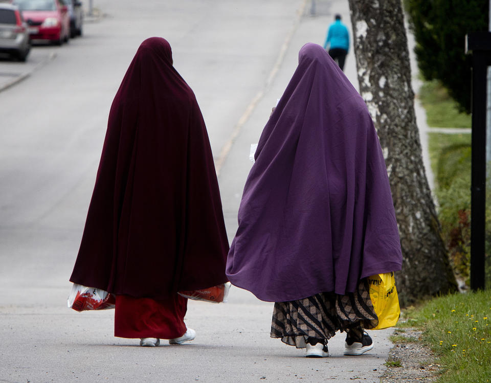 In this Aug. 30, 2018 photo migrants from Somalia walk through Flen, some 100 km west of Stockholm, Sweden. The town has welcomed so many asylum seekers in recent years that they now make up about a fourth of the population. (AP Photo/Michael Probst)