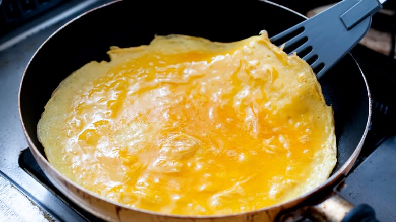 Cooking omelet in pan 