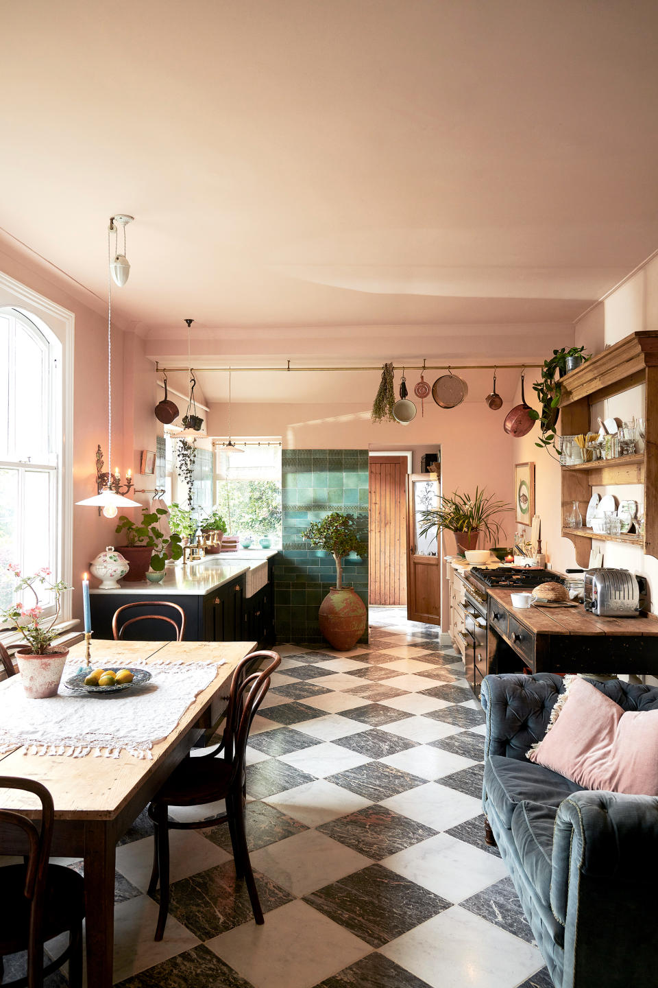 Black kitchen cabinets with pink walls and ceiling