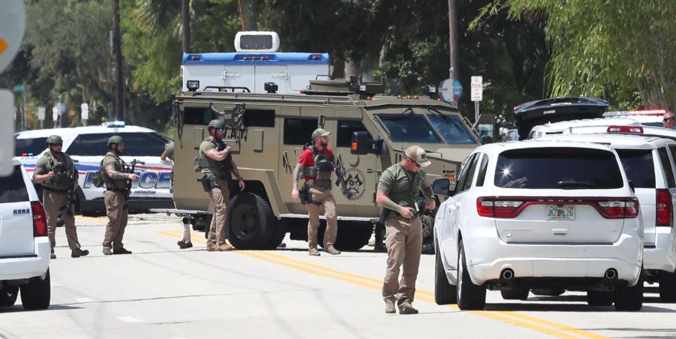 SWAT team members spread out in a neighborhood at an apartment in the 600 block of North Halifax  Avenue in Daytona Beach on Tuesday. Police were looking for Chad Keene, a suspect police said shot and killed a woman in a possible love triangle dispute.