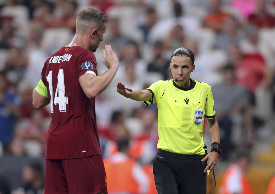 Referee Stephanie Frappart of France, right, discusses with Liverpool's Jordan Henderson during the UEFA Super Cup soccer match between Liverpool and Chelsea, in Besiktas Park, in Istanbul, Wednesday, Aug. 14, 2019. (AP Photo)