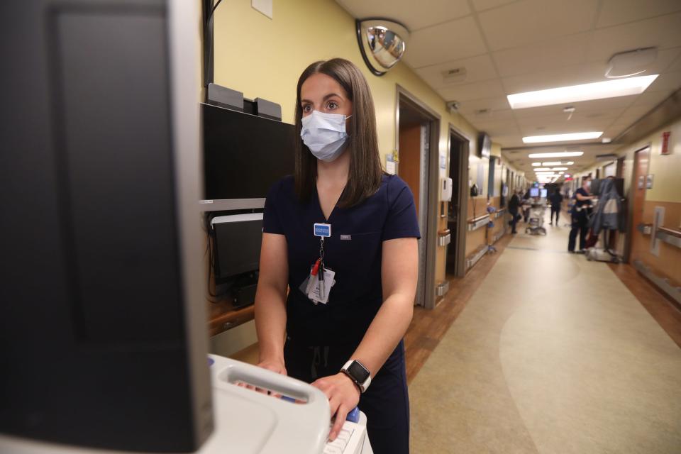 Nurse Kendall Piccirilli uses a standing work station in the hallway at Unity Hospital in Greece, N.Y. on October 27, 2021.