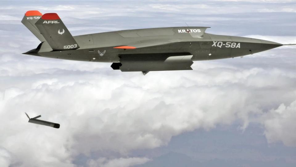 An XQ-58A Valkyrie releases an ALTIUS 600 drone using a launcher in its internal payload bay during a test in December 2020., <em>USAF</em>