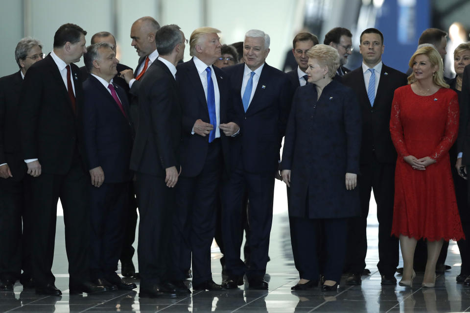 FILE - U.S. President Donald Trump, center, stands between Montenegro Prime Minister Dusko Markovic, center right, and NATO Secretary General Jens Stoltenberg, center left, during a NATO summit in Brussels Thursday, May 25, 2017. As Trump becomes the first former president to face federal charges that could put him in jail, many Europeans are watching the case closely. But hardly a single world leader has said a word recently about the man leading the race for the Republican party nomination. (AP Photo/Matt Dunham, File)