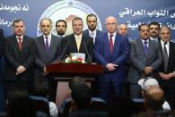 Iraqi Deputy Prime Minister Saleh al-Mutlaq (2L) and former parliament speaker Osama al-Nujaifi (3R) listen on as Sunni Muslim MP Dhafer al-Aanie (C) give a press conference after the new parliament failed to elect a speaker on July 1, 2014