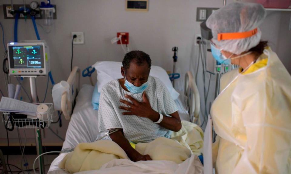 A healthcare worker tends to a patient in the Covid-19 Unit at United Memorial Medical Center in Houston, Texas.