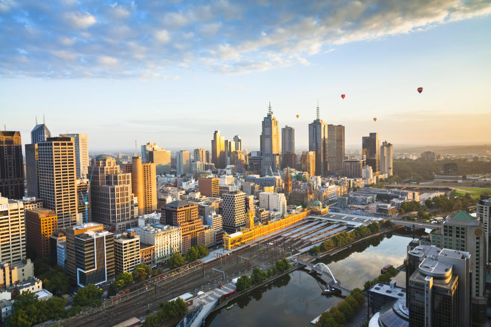 Hot air balloons aloft over Melbourne city at dawn, Victoria, Australia. (Photo: Gettyimages)