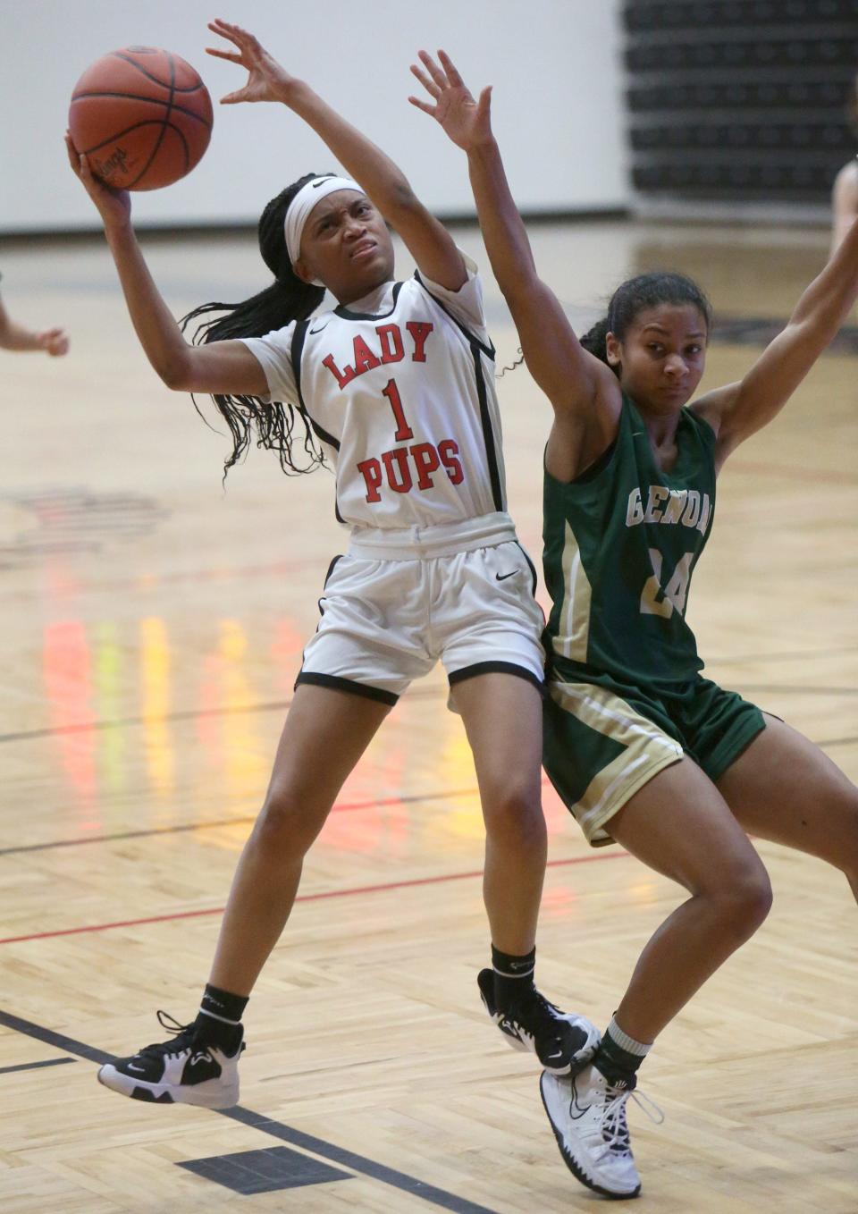 Ky'Lonee Foster (1) of McKinley drives into the lane while being defended by Breezie Williams (24) of GlenOak during their game at McKinley on Wednesday.