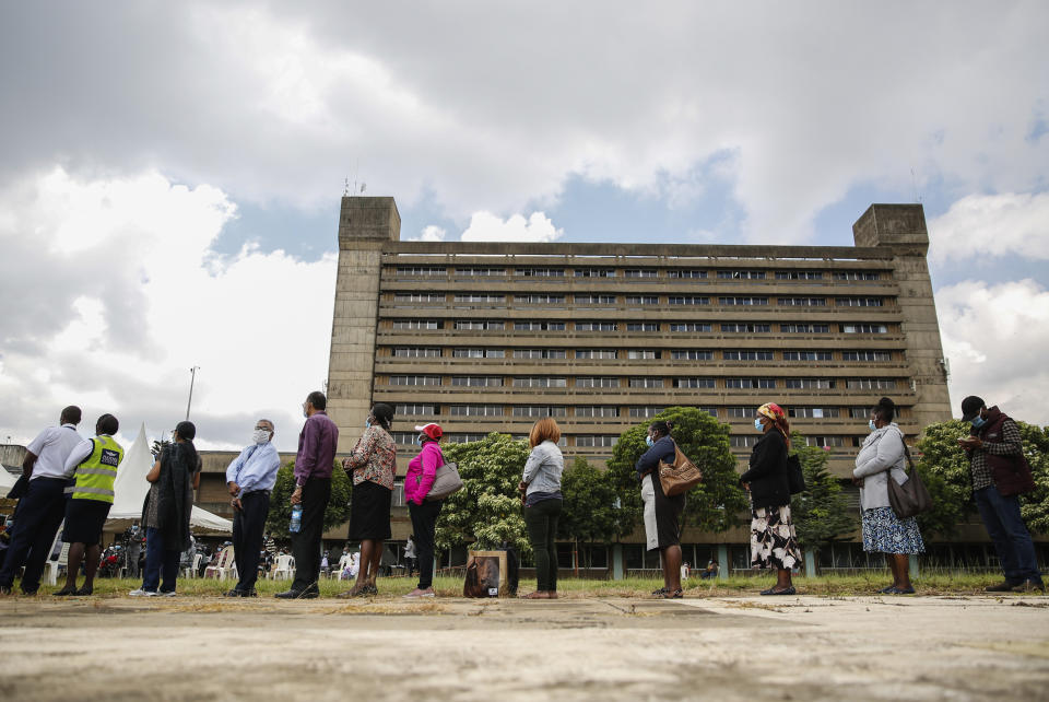 Kenyans line up to receive a dose of the AstraZeneca COVID-19 vaccine manufactured by the Serum Institute of India and provided through the global COVAX initiative, at Kenyatta National Hospital in Nairobi, Tuesday, April 6, 2021. (AP Photo/Brian Ingasnga)