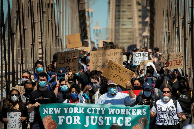 Current and former New York City Mayor's staff march across the Brooklyn Bridge to call for reforms during a protest against racial inequality in the aftermath of the death in Minneapolis police custody of George Floyd, in New York