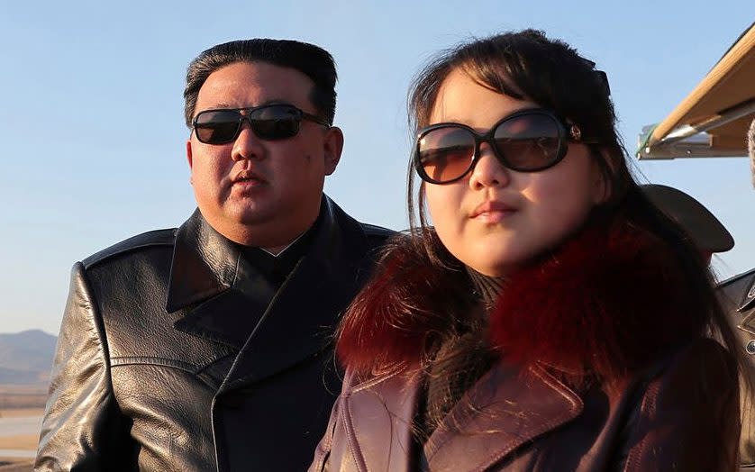 Kim Jong-un and daughter sport leather trenchcoats and sunglasses as they inspect 'dazzling' new aircraft