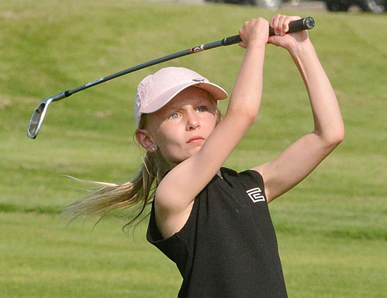 Anna Lunzman of Watertown (9-and-under girls) follows through after hitting a fairway shot on No. 1 Blue during the South Dakota Golf Association Junior Tour stop on Tuesday, July 9, 2024 at Cattail Crossing Golf Course in Watertown.