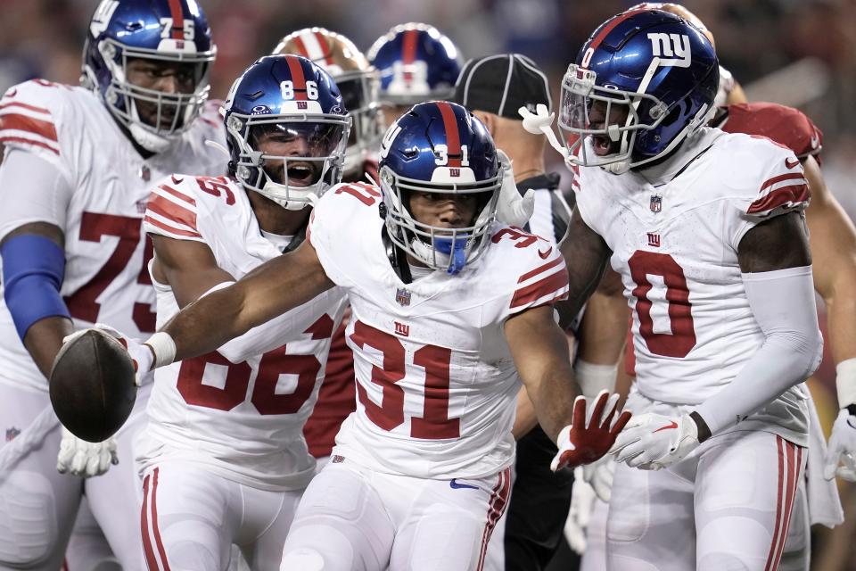 New York Giants running back Matt Breida (31) is congratulated by teammates after scoring against the San Francisco 49ers during the second half of an NFL football game in Santa Clara, Calif., Thursday, Sept. 21, 2023. (AP Photo/Godofredo A. Vásquez)