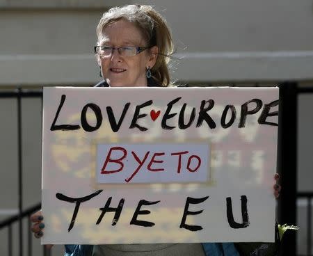 A woman holds a sign in Westminster, in central London, Britain June 24, 2016. REUTERS/Phil Noble