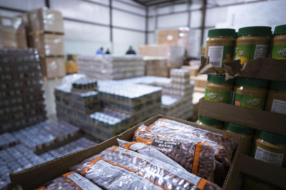 Food items wait to be packaged and distributed at Feeding America food bank in Elizabethtown, Ky., Monday, Jan. 17, 2022. Food banks across the country are experiencing a critical shortage of volunteers as the omicron variant frightens people away from group activities. (AP Photo/Michael Clubb)