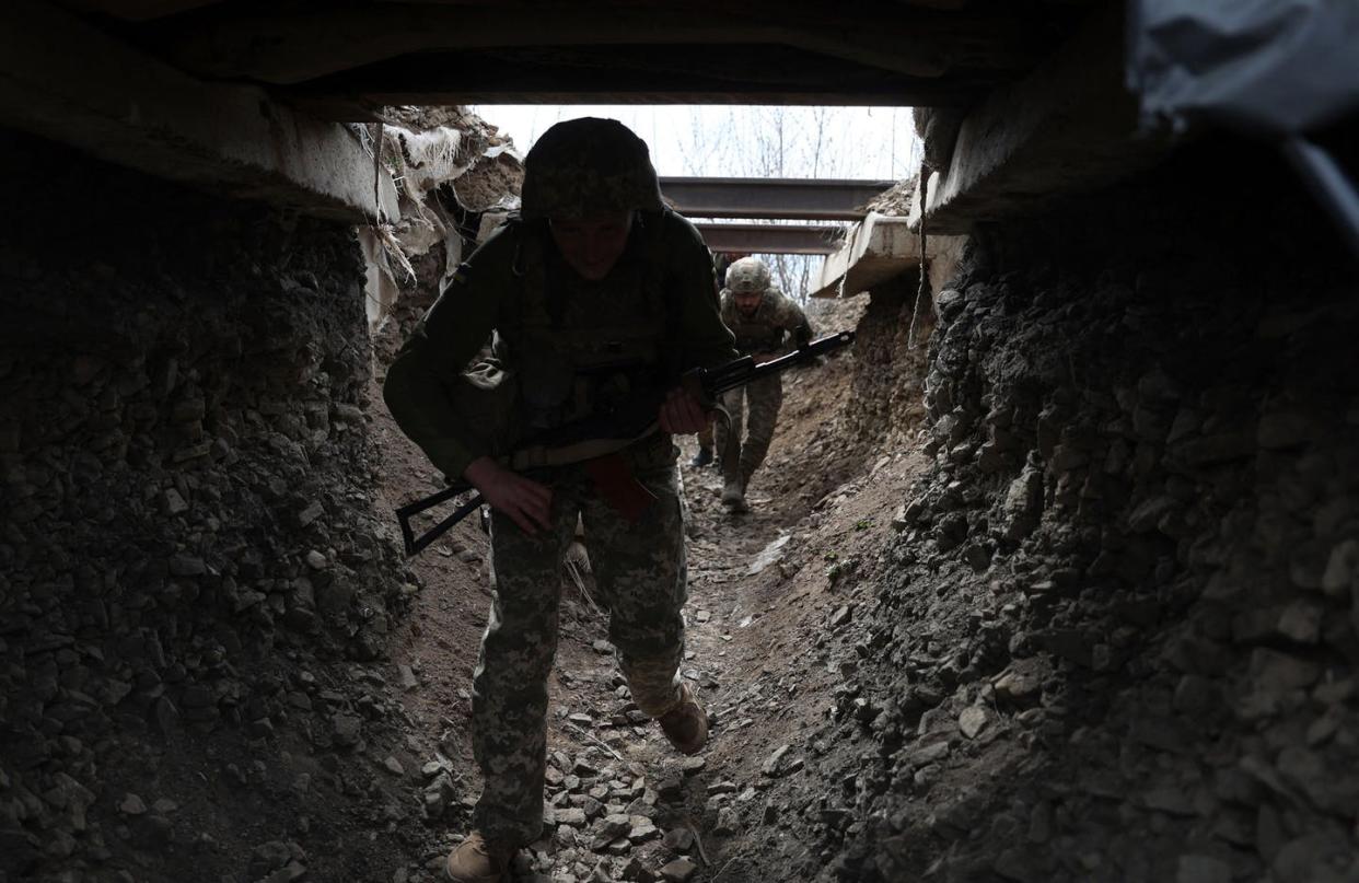 <span class="caption">Ukrainian fighters entering a tunnel.</span> <span class="attribution"><a class="link " href="https://www.gettyimages.com/detail/news-photo/ukrainian-soldiers-walk-through-a-tunnel-of-a-trench-on-the-news-photo/1239919477?adppopup=true" rel="nofollow noopener" target="_blank" data-ylk="slk:Anatolii Stepanov/AFP via Getty Images;elm:context_link;itc:0;sec:content-canvas">Anatolii Stepanov/AFP via Getty Images</a></span>