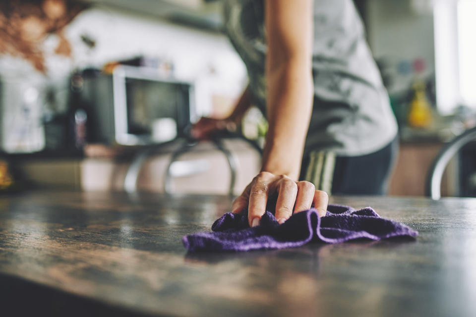 a person wiping down a counter