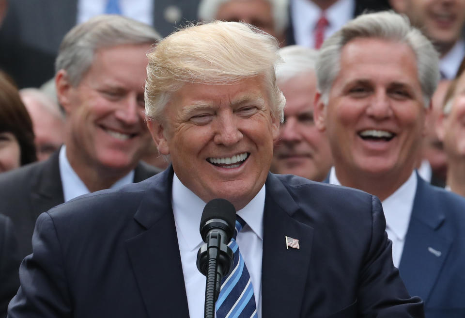 U.S. President Donald Trump speaks with House Freedom Caucus Chairman Mark Meadows (L) and House Majority Leader Kevin McCarthy (R) behind him as Trump gathered with Congressional Republicans in the Rose Garden of the White House after the House of Representatives approved the American Healthcare Act, to repeal major parts of Obamacare and replace it with the Republican healthcare plan, in Washington, U.S., May 4, 2017. REUTERS/Carlos Barria