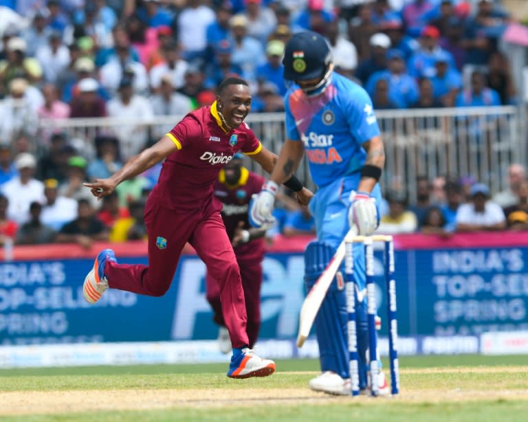 Dwayne Bravo (L) of West Indies celebrates the dismissal of Virat Kohli (R) of India during the 1st T20i between West Indies and India at Central Broward Stadium in Fort Lauderdale, Florida, on August 27, 2016