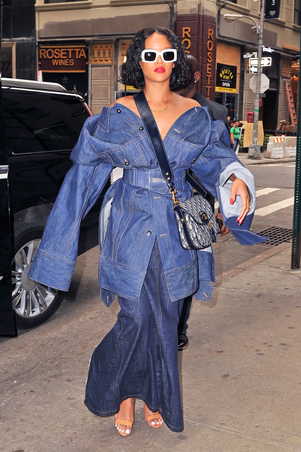 <p>In an oversized belted denim jacket, wide-leg jeans, nude sandals rectangular white RAEN sunglasses and a Dior crossbody bag while out in New York. </p>