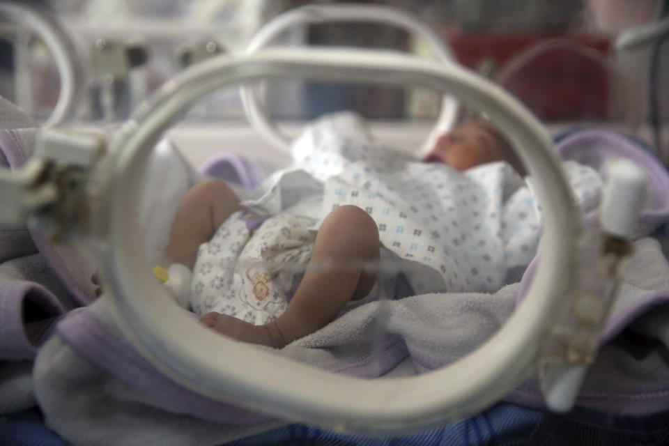 Newborn babies lie in their cribs at the Ataturk Children's Hospital a day after being rescued from another maternity hospital following a deadly attack, in Kabul, Afghanistan, Wednesday, May 13, 2020. Militants stormed the Barchi National Maternity Hospital in the western part of Kabul on Tuesday, setting off an hours-long shootout with the police and killing tens of people, including two newborn babies, their mothers and an unspecified number of nurses, Afghan officials said. (AP Photo/Rahmat Gul)