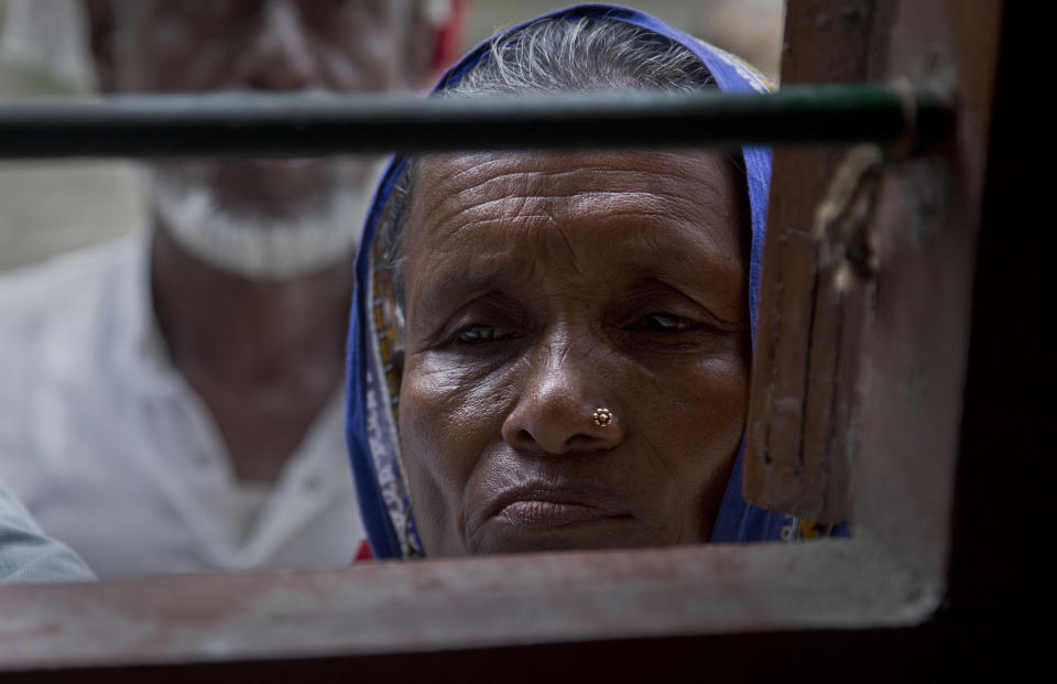 In this Aug. 31, 2019 photo, villagers wait to check their names in the final list of National Register of Citizens in Morigaon district, Assam, India. About 1.9 million people were left out of the National Register of Citizens _ a mammoth exercise to weed out illegal mainly Bangladeshi immigrants from Assam’s more than 32 million people. (AP Photo/Anupam Nath)