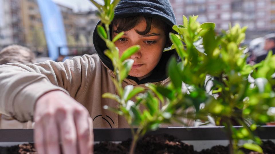 a student taking part in a planting competition 