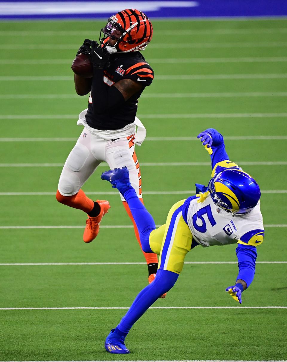 Feb 13, 2022; Inglewood, California, USA; Cincinnati Bengals receiver Tee Higgins (85) makes a touchdown reception against Los Angeles Rams cornerback Jalen Ramsey (5) in the third quarter of Super Bowl LVI at SoFi Stadium. Mandatory Credit: Gary A. Vasquez-USA TODAY Sports