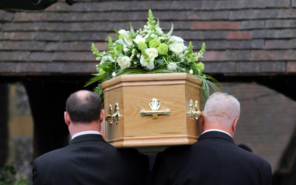 Funeral operator Dignity is freezing the price of traditional funerals and cutting the price of 'simple' funerals following a profit warning. - PA