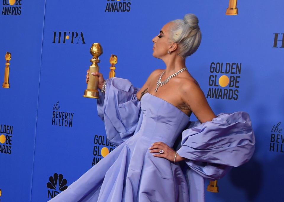 TOPSHOT – Winner for Best Original Song – Motion Picture for ‘Shallow – A Star is Born’ Lady Gaga poses with the trophy during the 76th annual Golden Globe Awards on January 6, 2019, at the Beverly Hilton hotel in Beverly Hills, California. (Photo by Mark RALSTON / AFP) (Photo credit should read MARK RALSTON/AFP/Getty Images)