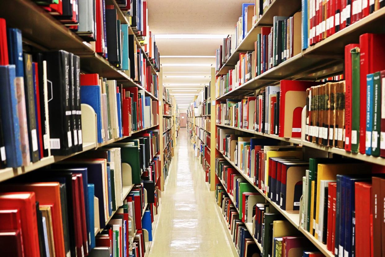 Aisle Amidst Bookshelves In Library