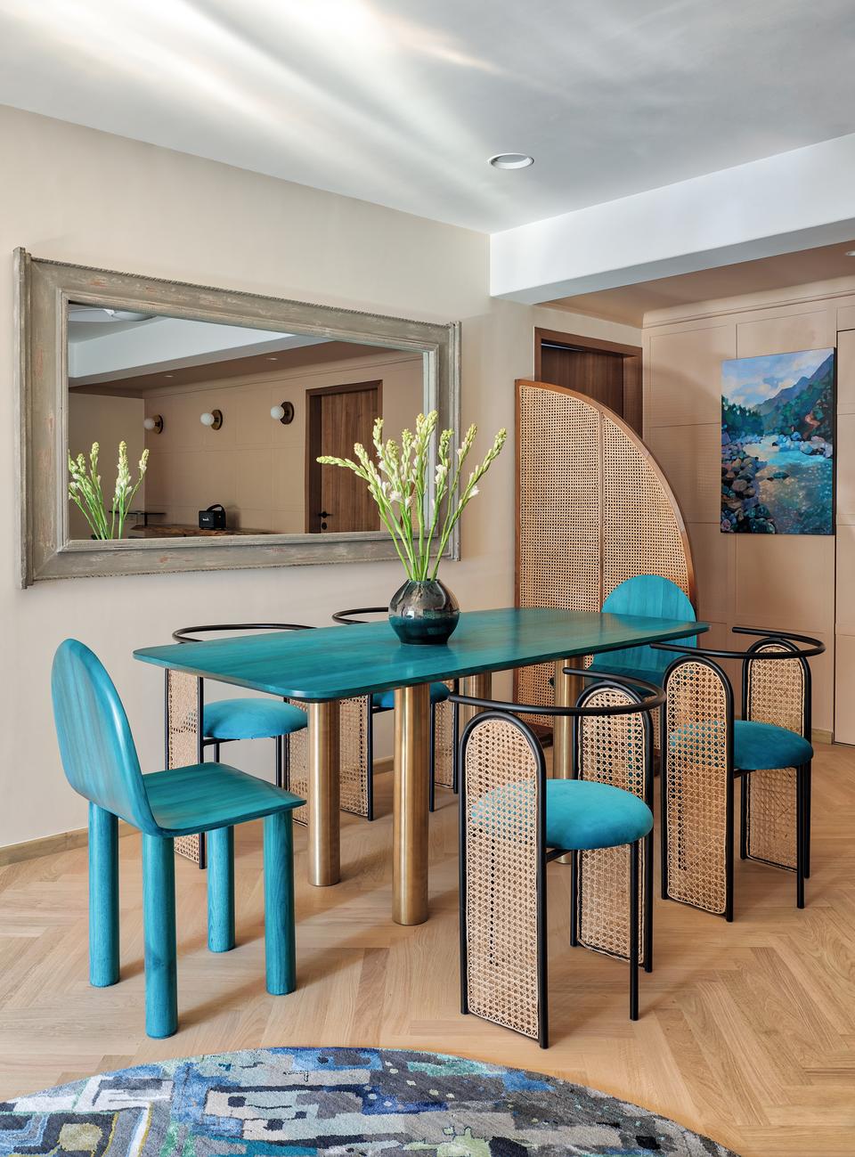 A dining room with turquoise blue furniture